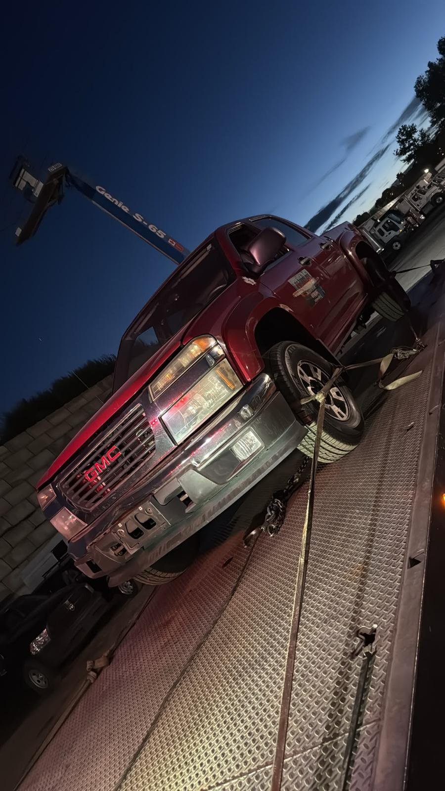 Red pickup truck on a vehicle carrier